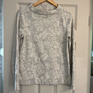Gray Loft sweater with white floral detail.